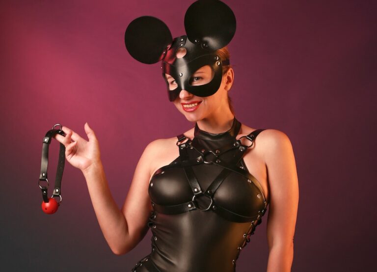 Model in Latex Costume with Mouse Ears Mask Holding Gag Ball