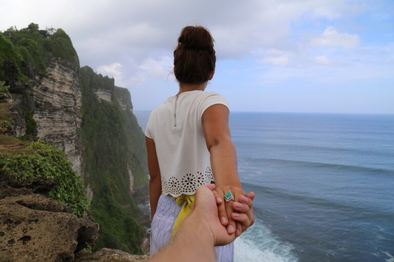 cliff, beach, holding hands
