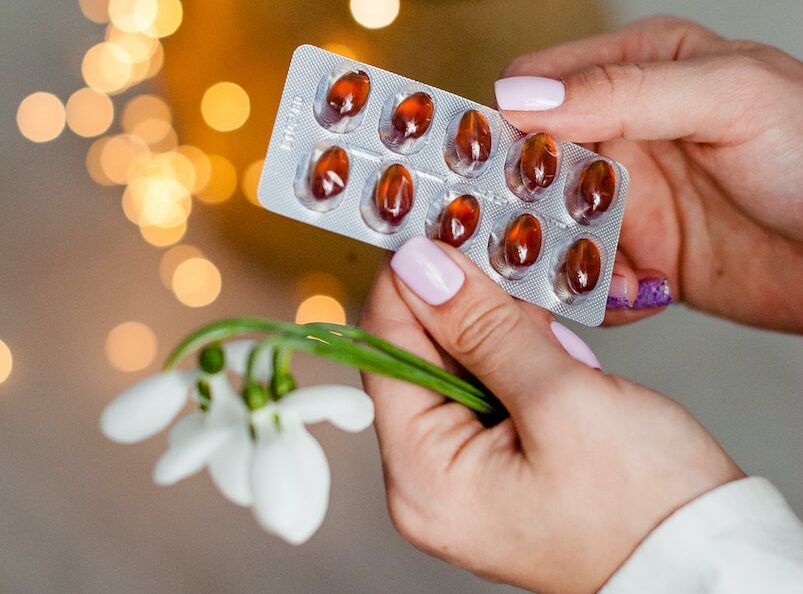 person holding silver blister pack